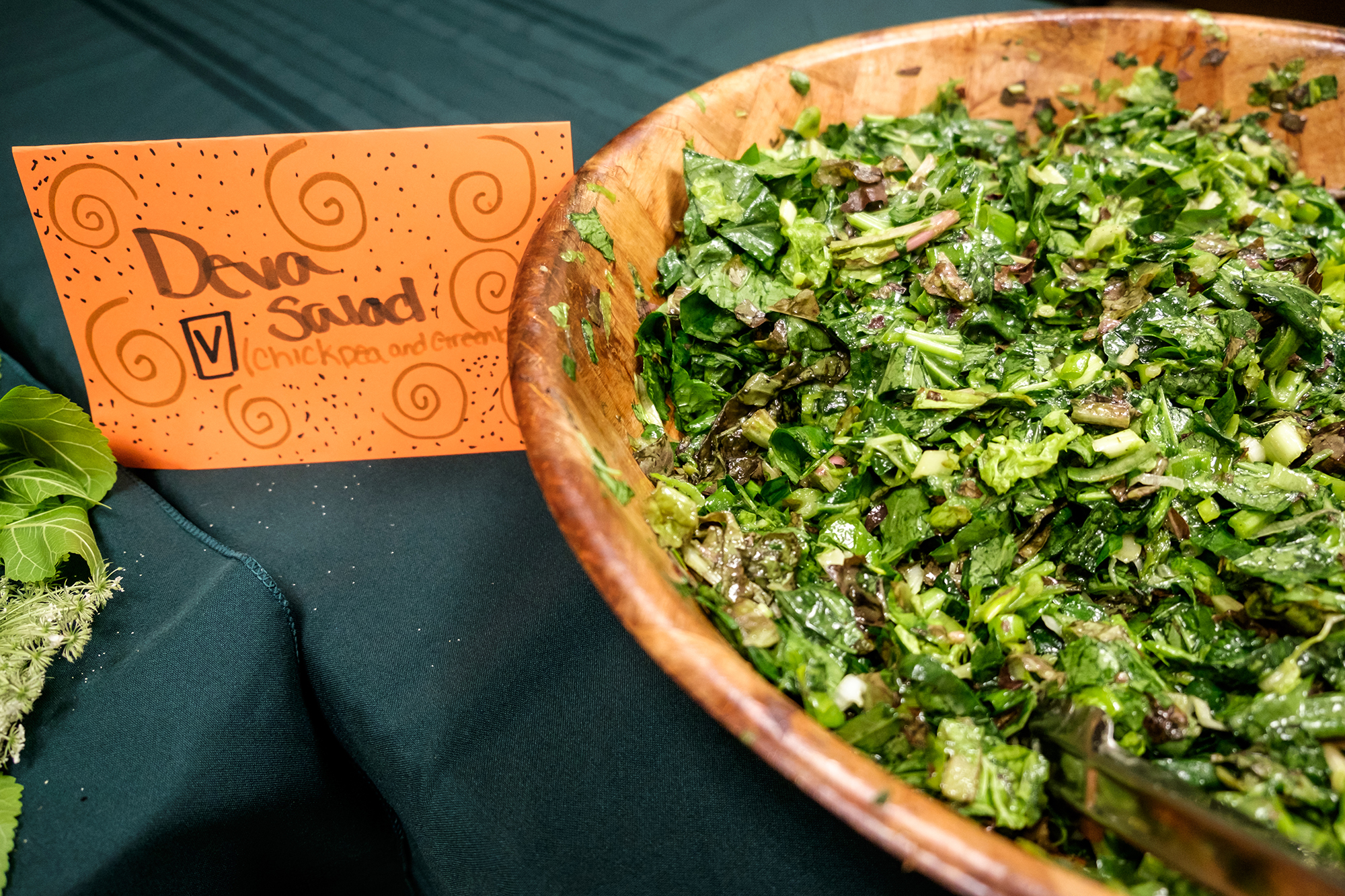 green deva salad in a wooden salad bowl