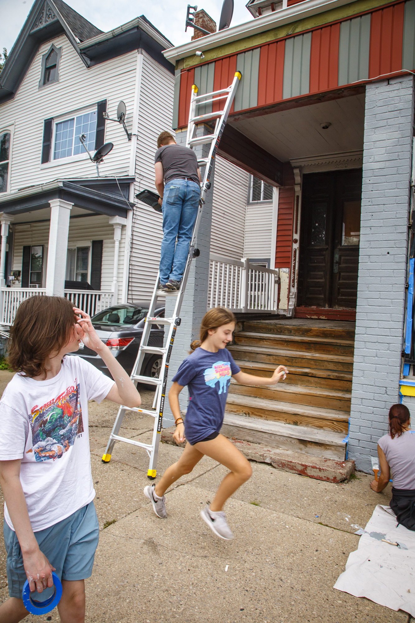 volunteers painting a house