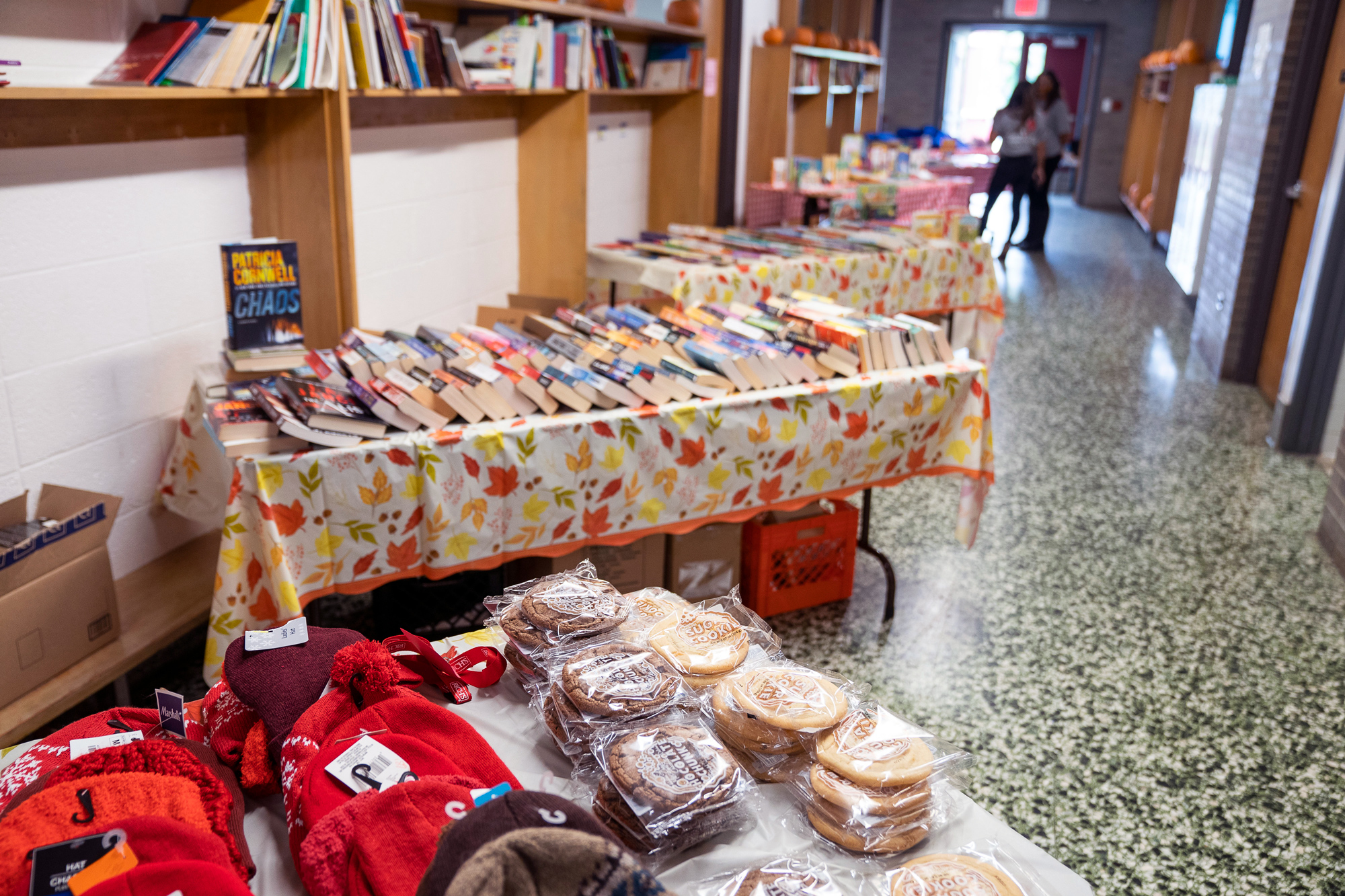 winter supplies, cookies, and books placed on top of tables in a school