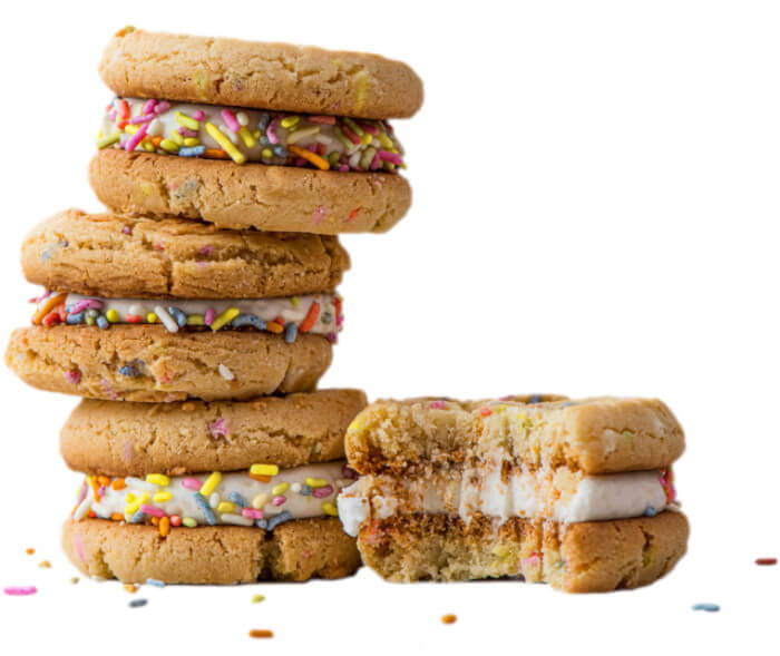 cookie sandwiches filled with icing and sprinkles